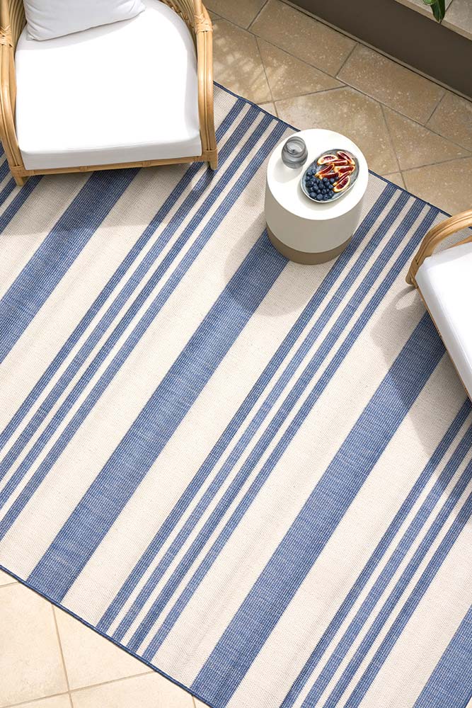 Ariel Blue outdoor rug – coastal striped flatweave design in blue and ivory, perfect for patios, decks, and indoor-outdoor spaces.