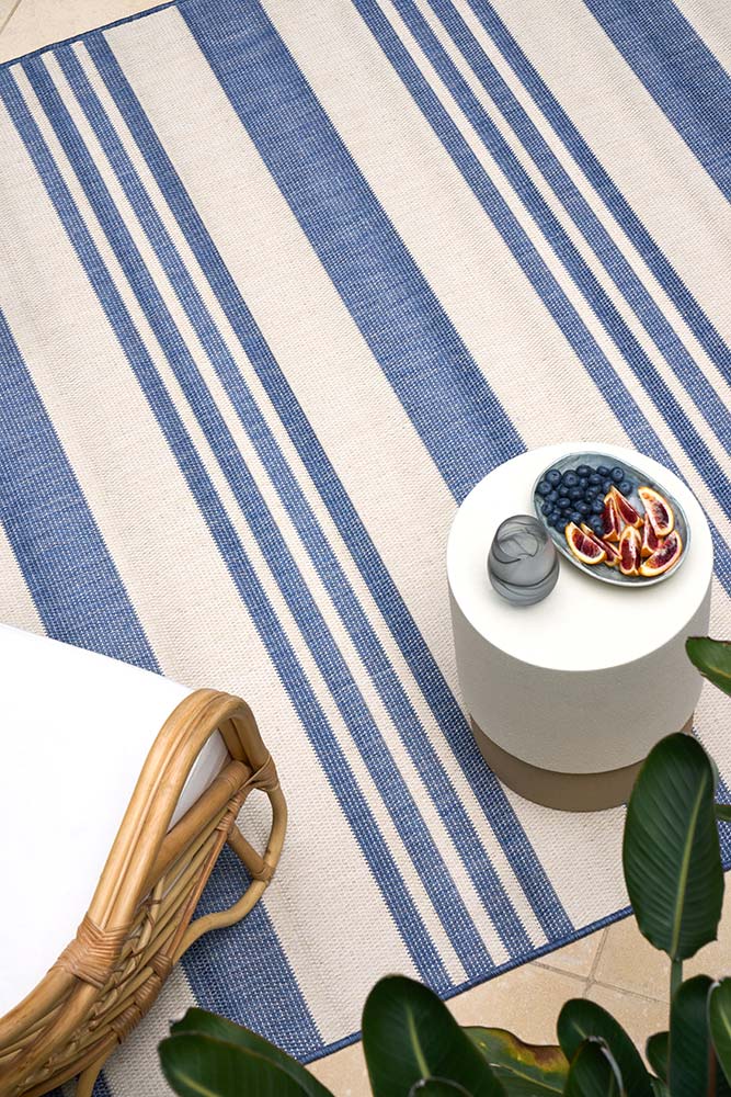 Ariel Blue outdoor rug – coastal striped flatweave design in blue and ivory, perfect for patios, decks, and indoor-outdoor spaces.