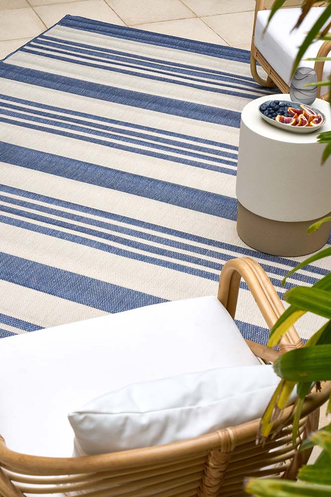 Ariel Blue outdoor rug – coastal striped flatweave design in blue and ivory, perfect for patios, decks, and indoor-outdoor spaces.