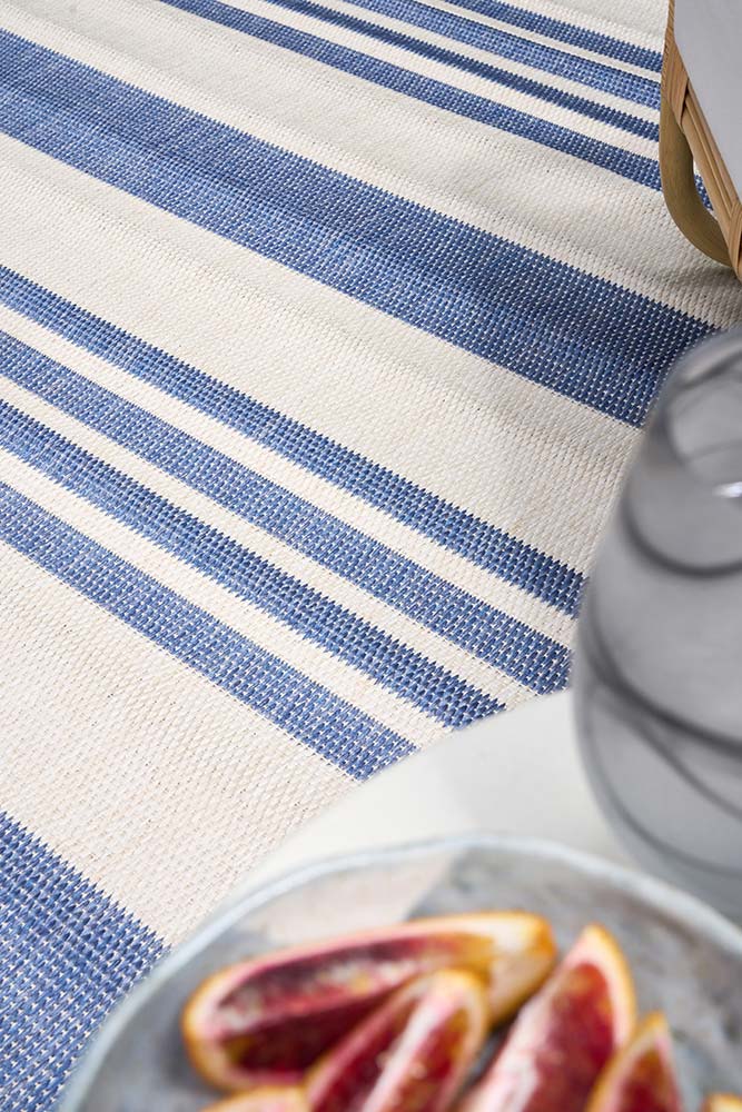 Ariel Blue outdoor rug – coastal striped flatweave design in blue and ivory, perfect for patios, decks, and indoor-outdoor spaces.