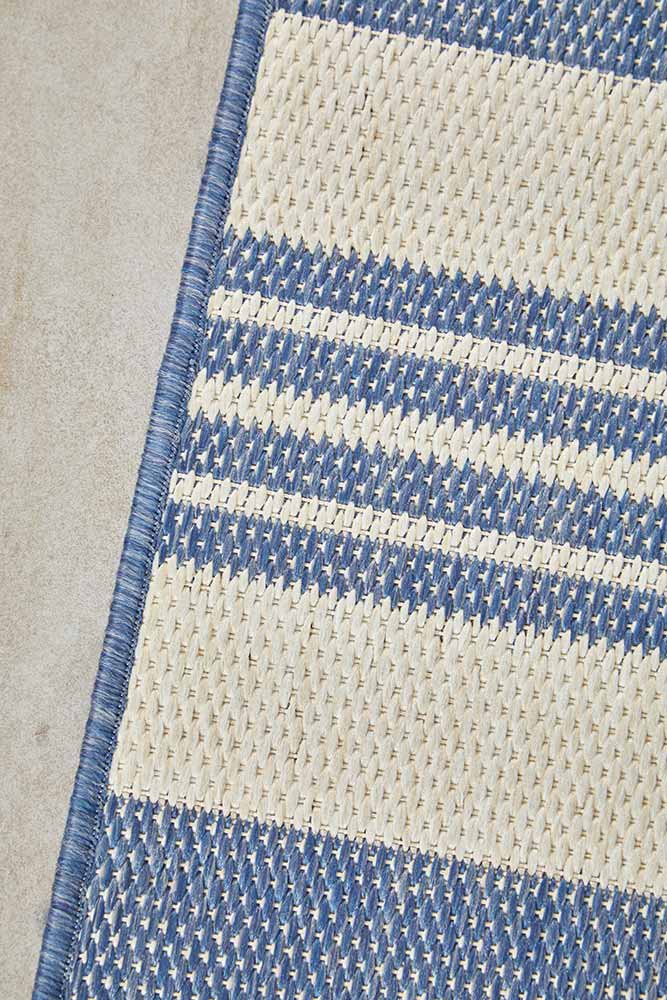 Ariel Blue outdoor rug – coastal striped flatweave design in blue and ivory, perfect for patios, decks, and indoor-outdoor spaces.