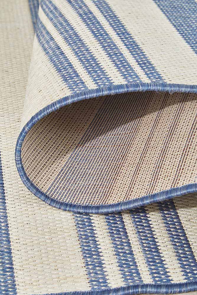 Ariel Blue outdoor rug – coastal striped flatweave design in blue and ivory, perfect for patios, decks, and indoor-outdoor spaces.