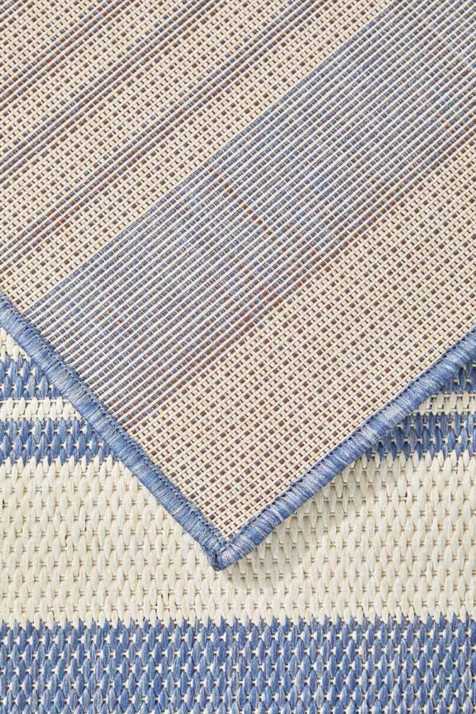 Ariel Blue outdoor rug – coastal striped flatweave design in blue and ivory, perfect for patios, decks, and indoor-outdoor spaces.