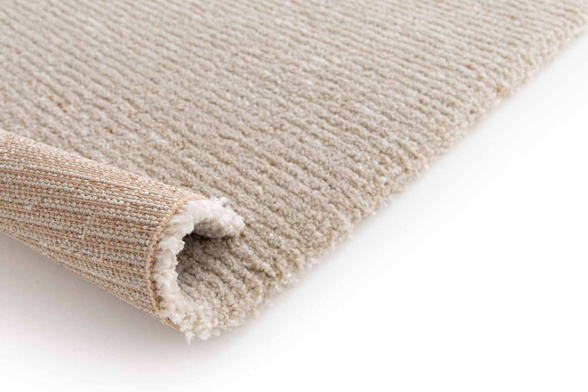 Cedric Sandstone beige rug with subtle caramel flecks and soft plush pile. Available at Rugs N Timber Belrose showroom