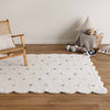 Como Cloud rug – cotton kids rug in soft white with subtle pastel dots and scalloped edge design, plush and lightweight. Available at Rugs N Timber Belrose