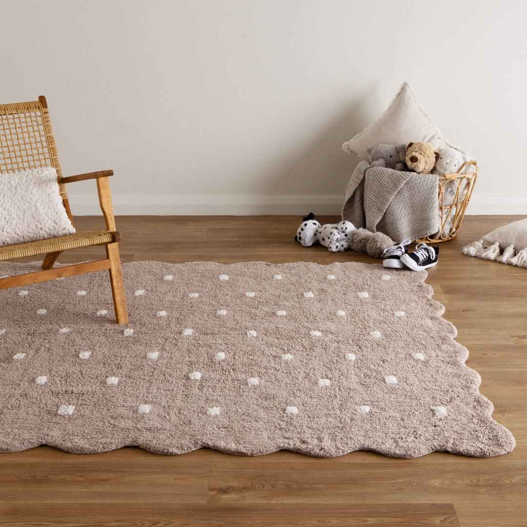 Como Mushroom rug – soft cotton kids rug in warm taupe with scalloped edge and dotted pattern, perfect for bedrooms and nurseries. Available at Rugs N Timber Belrose