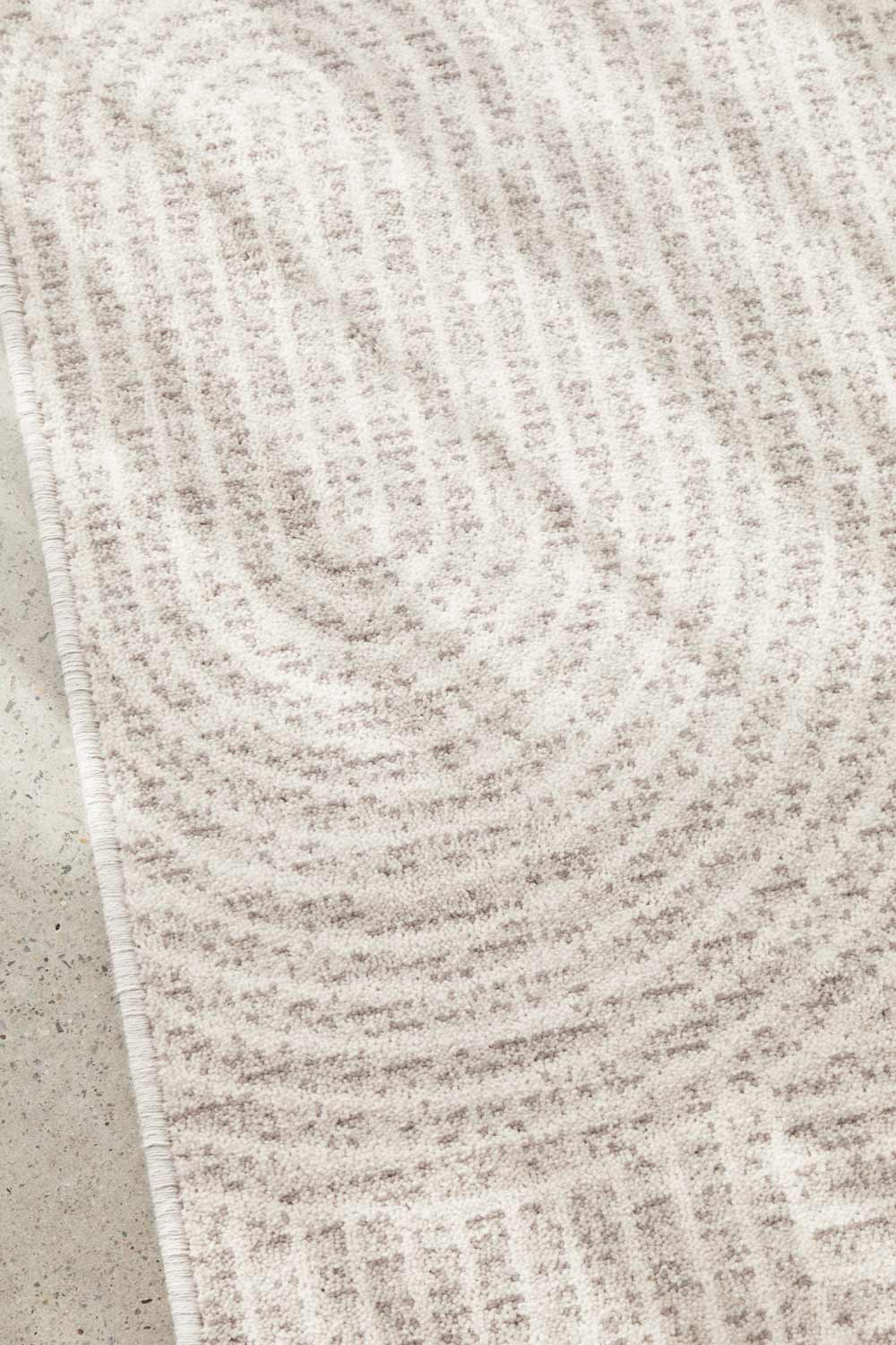 Close-up of a Madelyn Contour Rug on a concrete floor