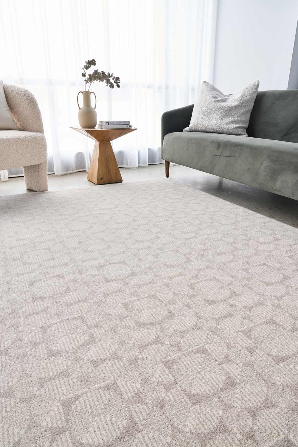 Living room shot of the Madelyn Tessera wool rug with its geometric pattern