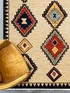 Walter Nomad Sand rug – tribal wool rug with cream base and colourful geometric diamond patterns, inspired by traditional design. Available at Rugs N Timber Belrose