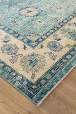 Azure Garden Afghan wool rug — teal field with floral medallions and cream border — handmade, natural dyes