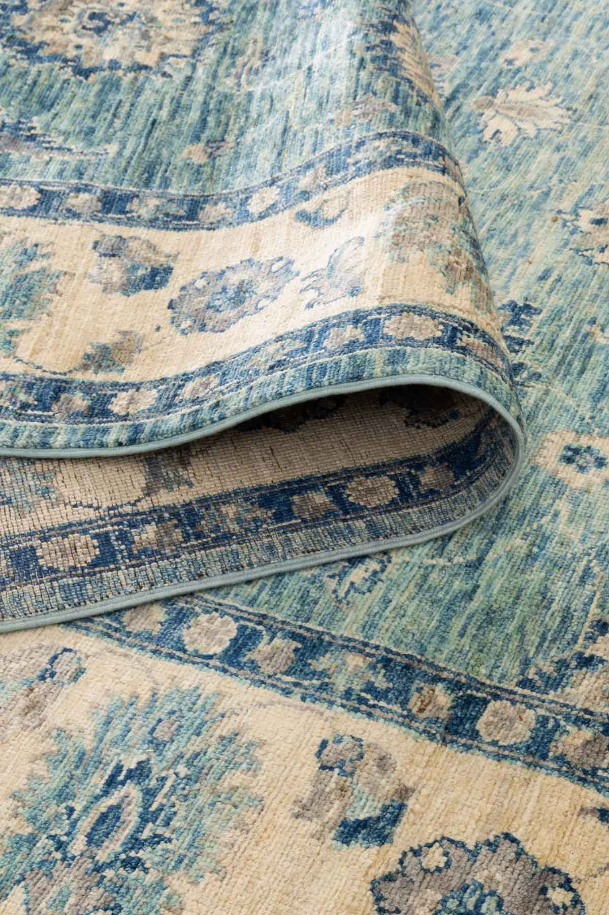 Azure Garden Afghan wool rug — teal field with floral medallions and cream border — handmade, natural dyes