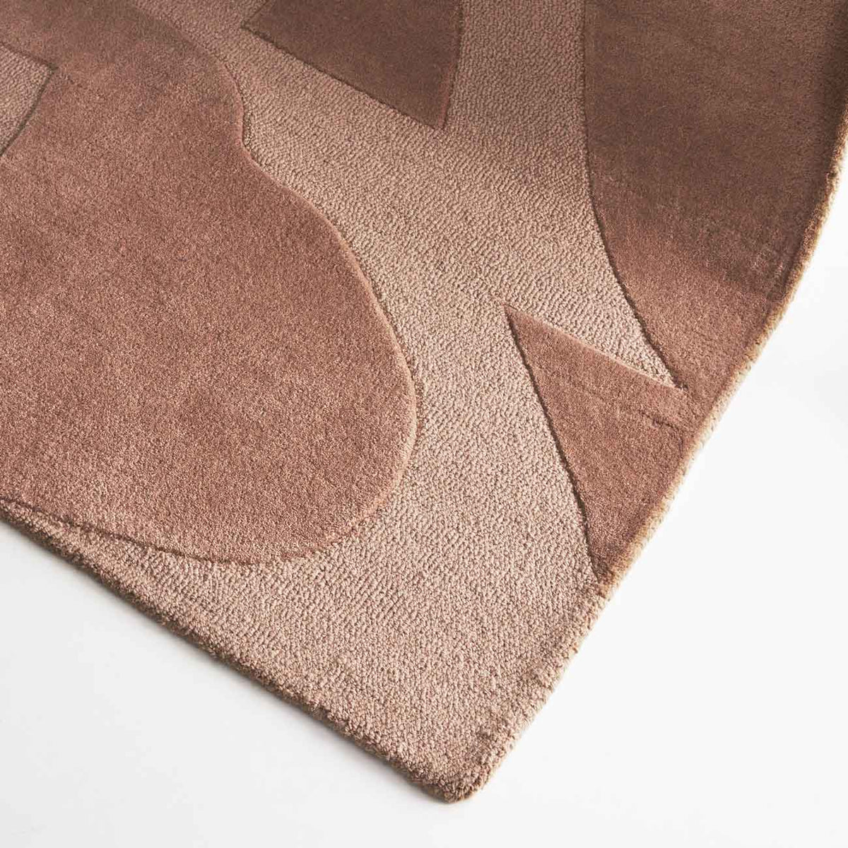 Canyon Nude hand tufted wool rug with curved abstract design in soft peach and beige tones