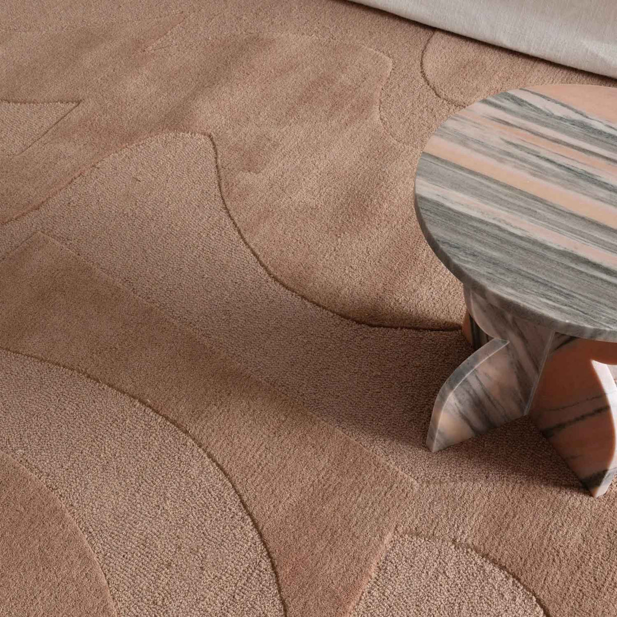 Canyon Nude hand tufted wool rug with curved abstract design in soft peach and beige tones