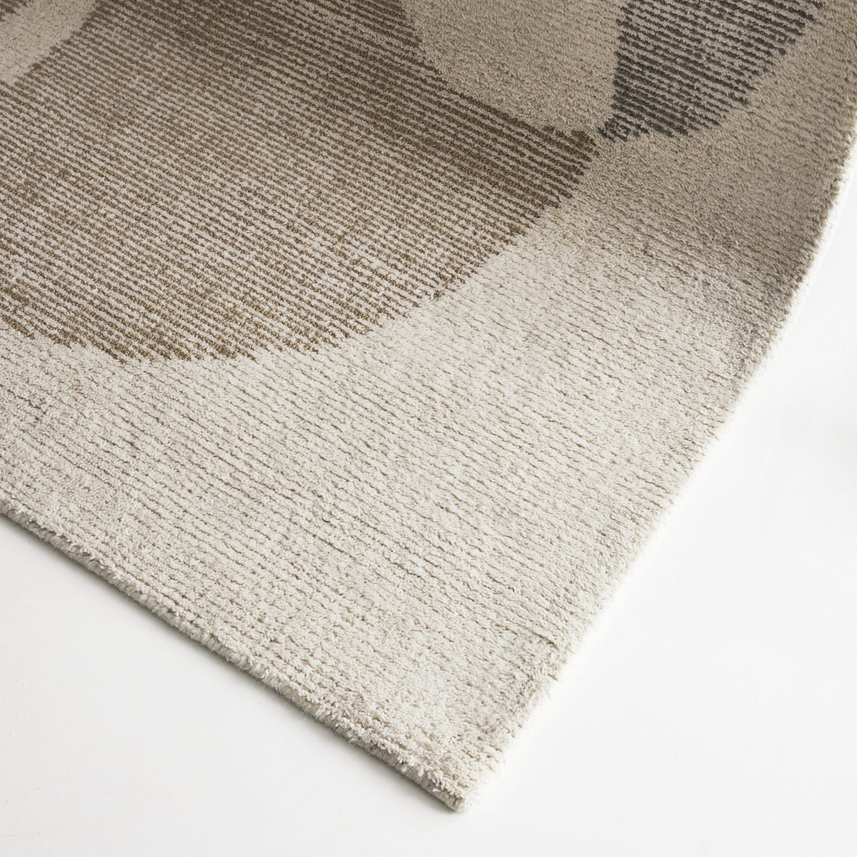 Cove Stone wool rug with large abstract design in ivory, stone and warm neutral tones