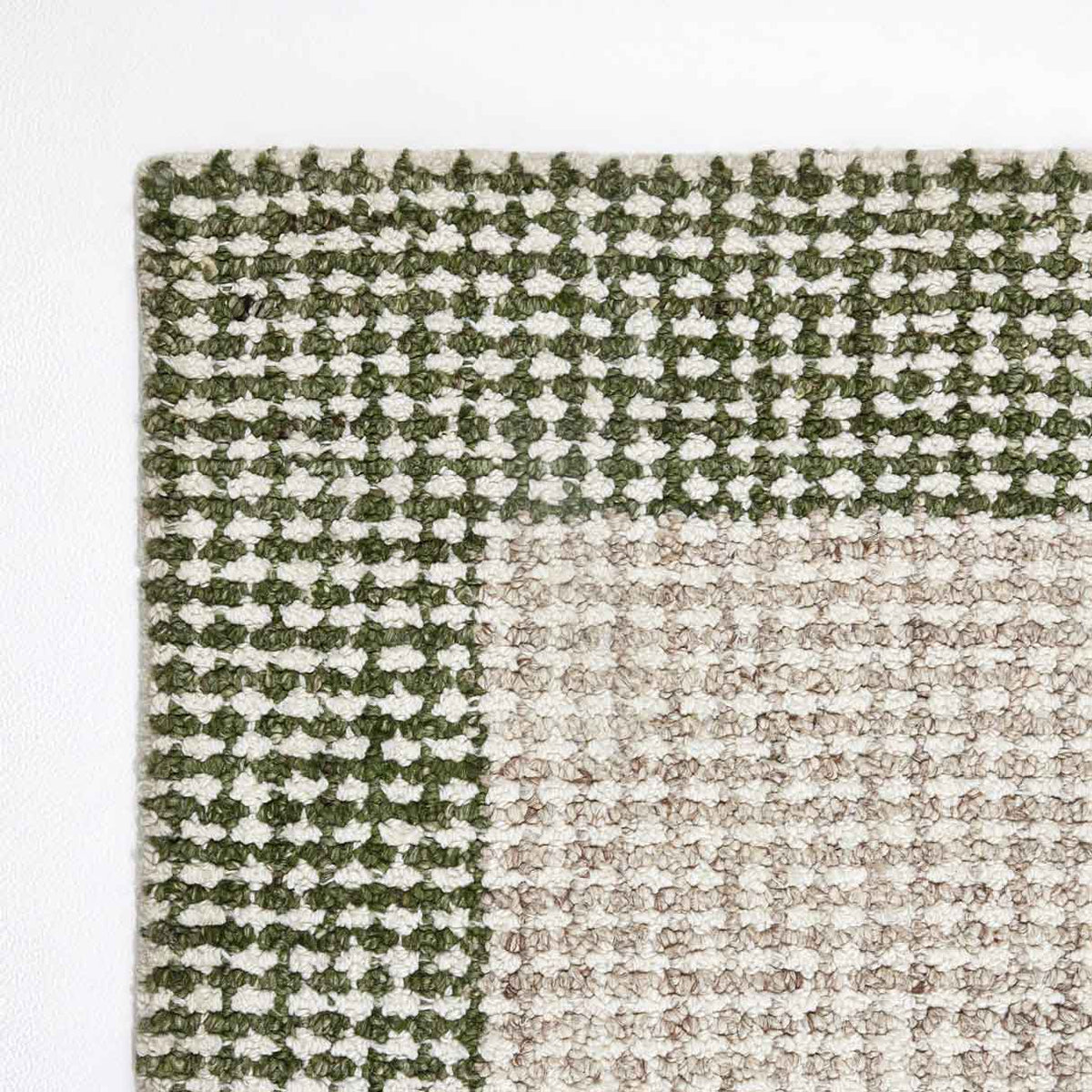 Grove green and ivory hand-woven wool rug with contrasting border design