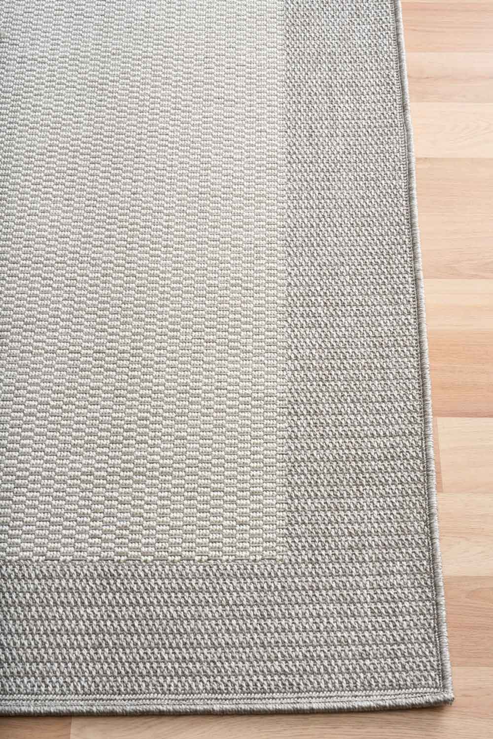 Linden Border Silver indoor outdoor rug with a light centre and soft grey framed edge. Available at Rugs N Timber Belrose