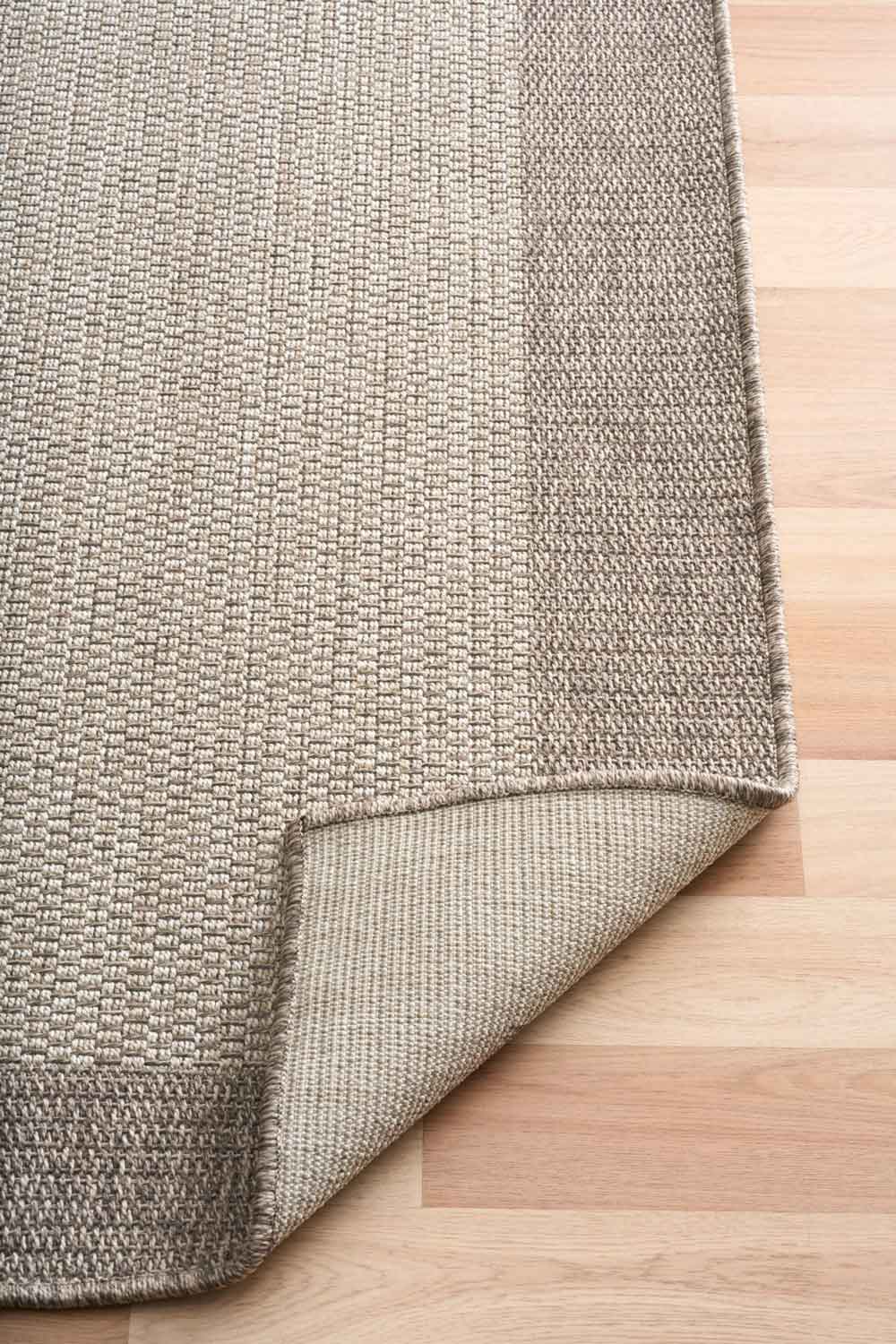 Linden Border Stone indoor outdoor rug with a neutral centre and warm taupe-grey border.  Available at Rugs N Timber Belrose