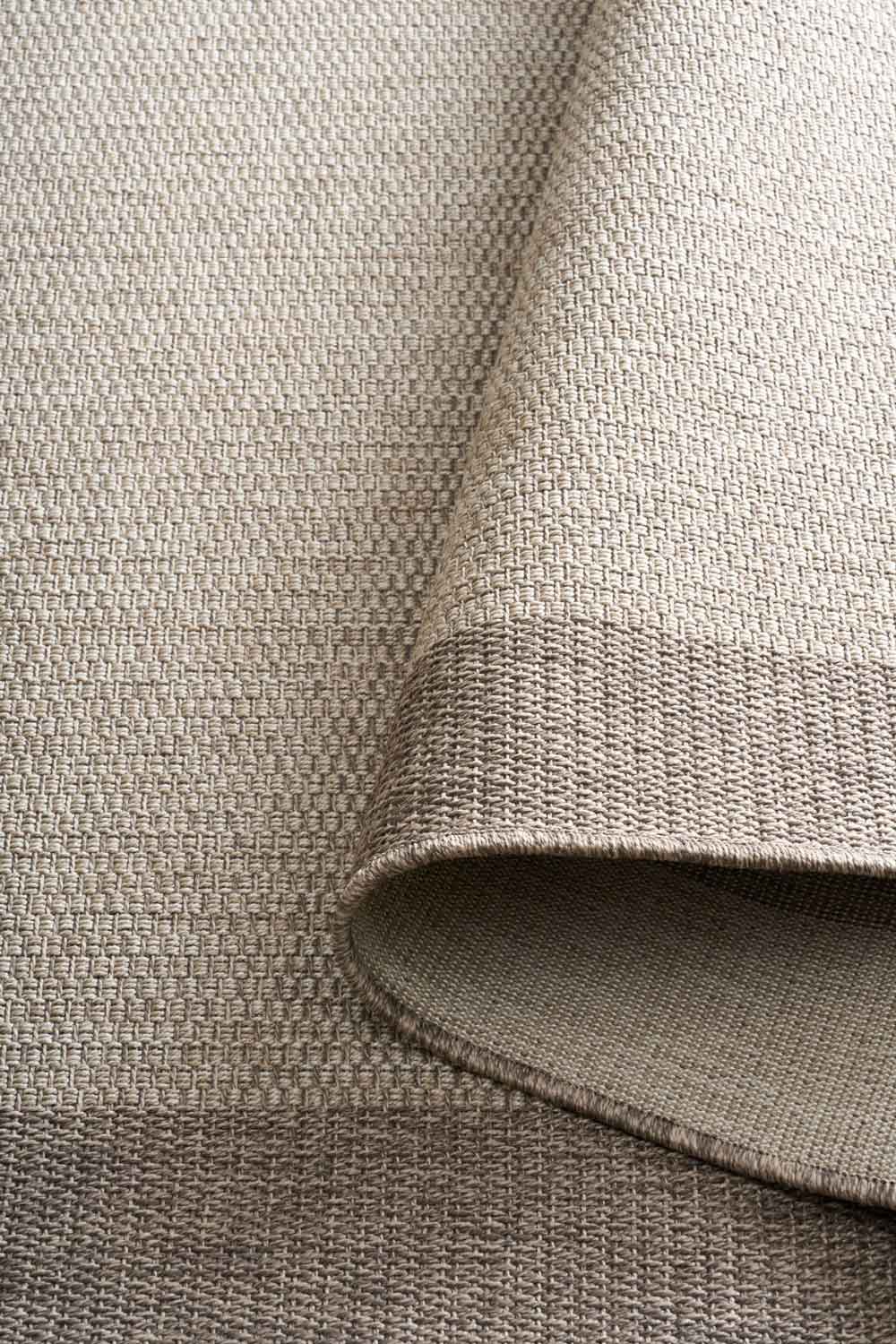 Linden Border Stone indoor outdoor rug with a neutral centre and warm taupe-grey border.  Available at Rugs N Timber Belrose