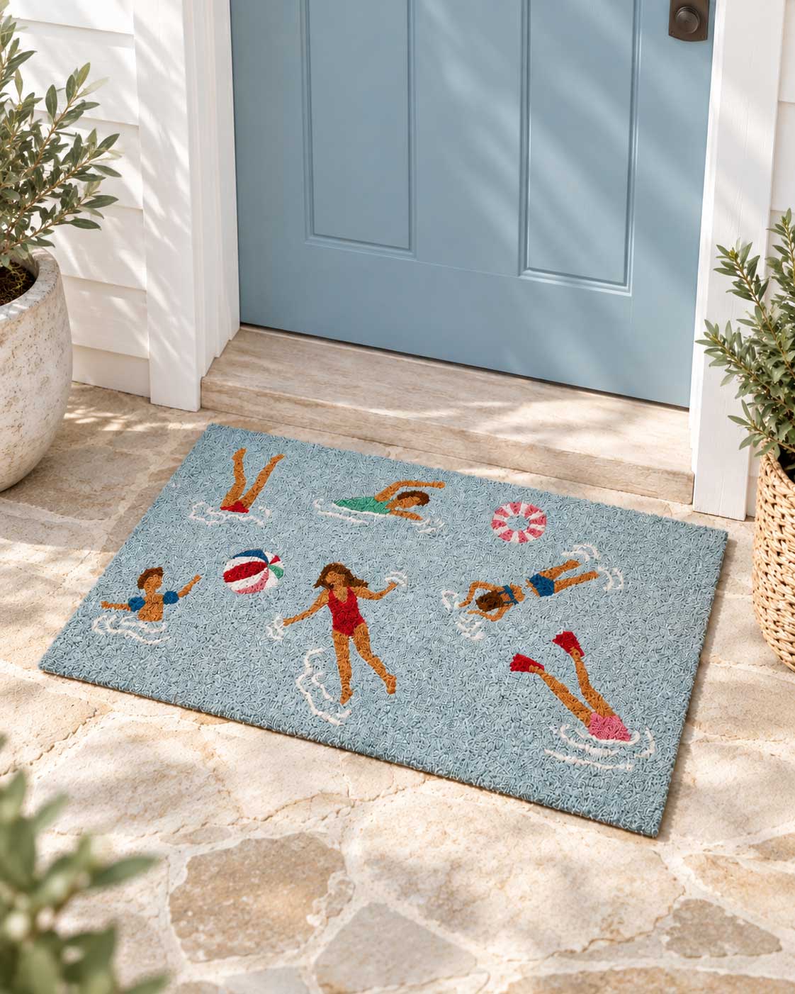 Ocean Swimmers coastal coir doormat styled at a beach house entrance