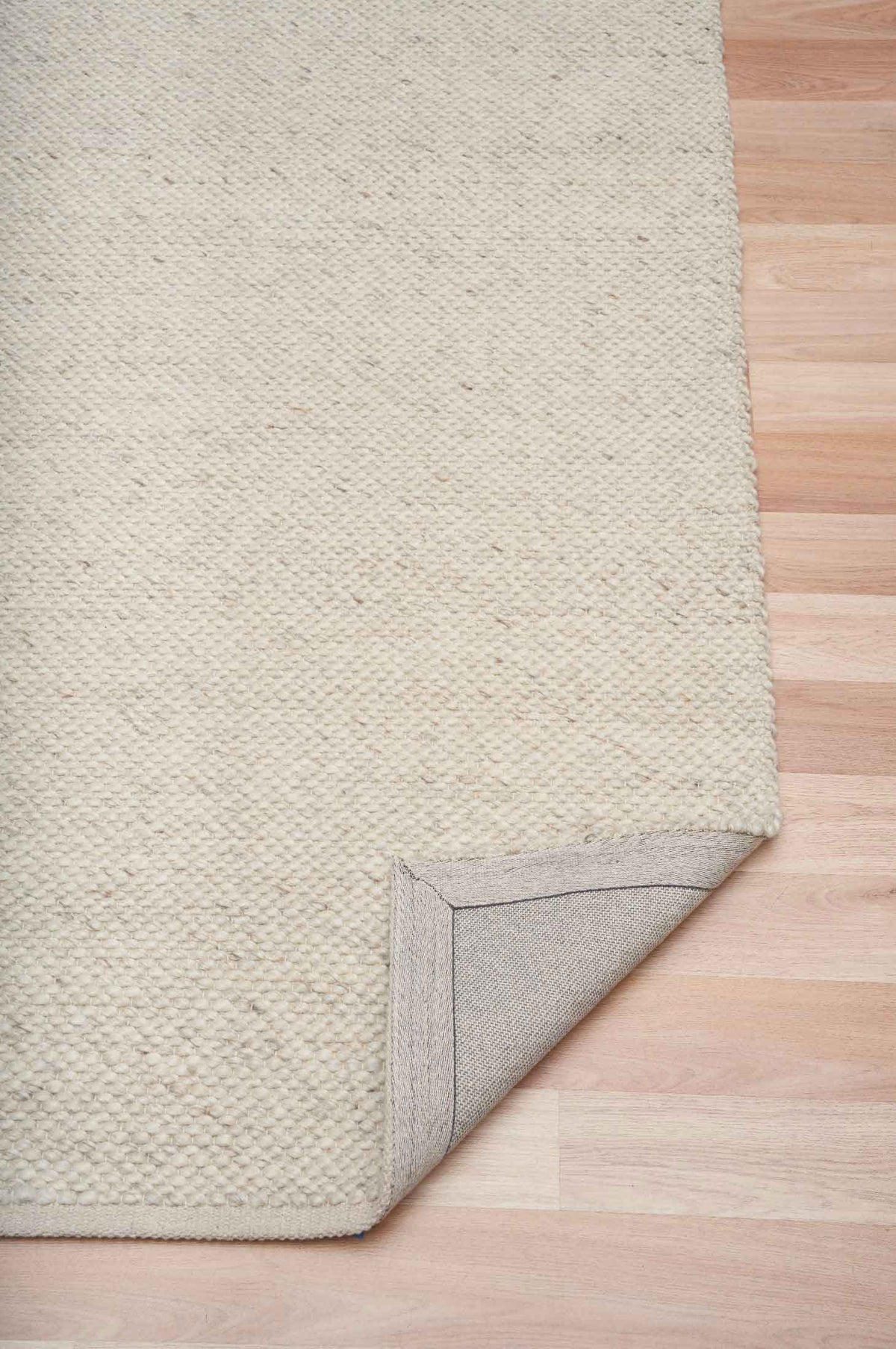 Morris Pearl textured wool rug with handwoven finish in a soft neutral tone, available at Rugs N Timber Belrose showroom