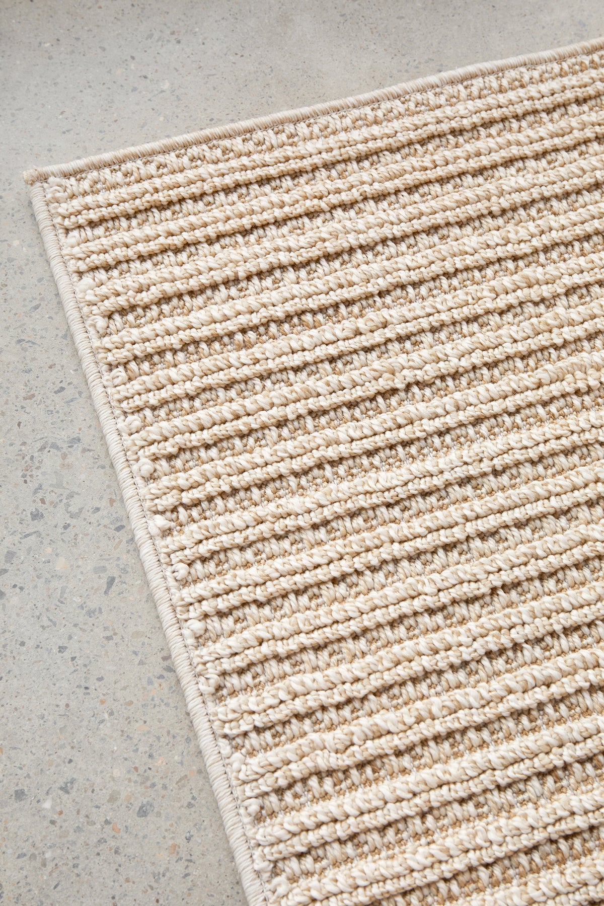 Serafina Latte indoor and outdoor rug with textured linear pattern at Rugs N Timber Belrose showroom