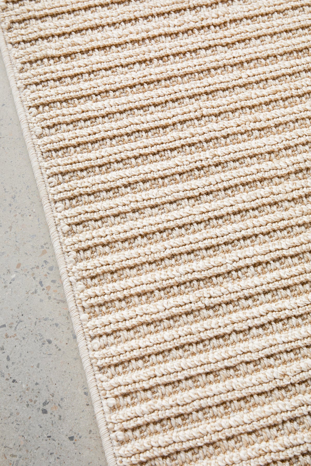 Serafina Latte indoor and outdoor rug with textured linear pattern at Rugs N Timber Belrose showroom