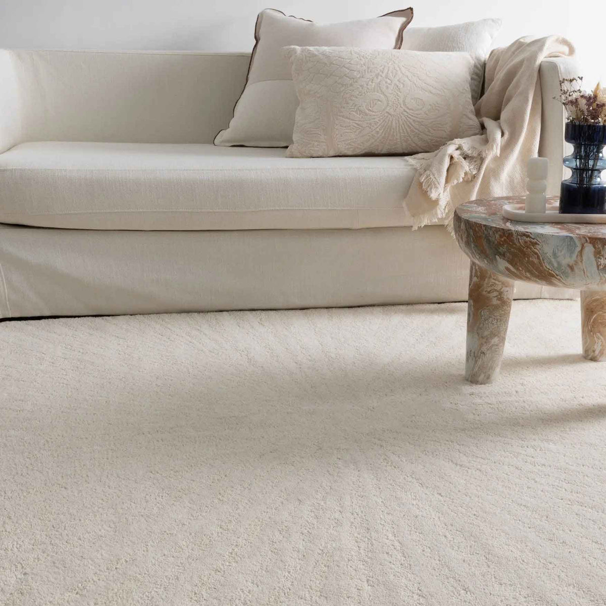 Solace Ivory wool rug with subtle radiating pattern in soft neutral tones
