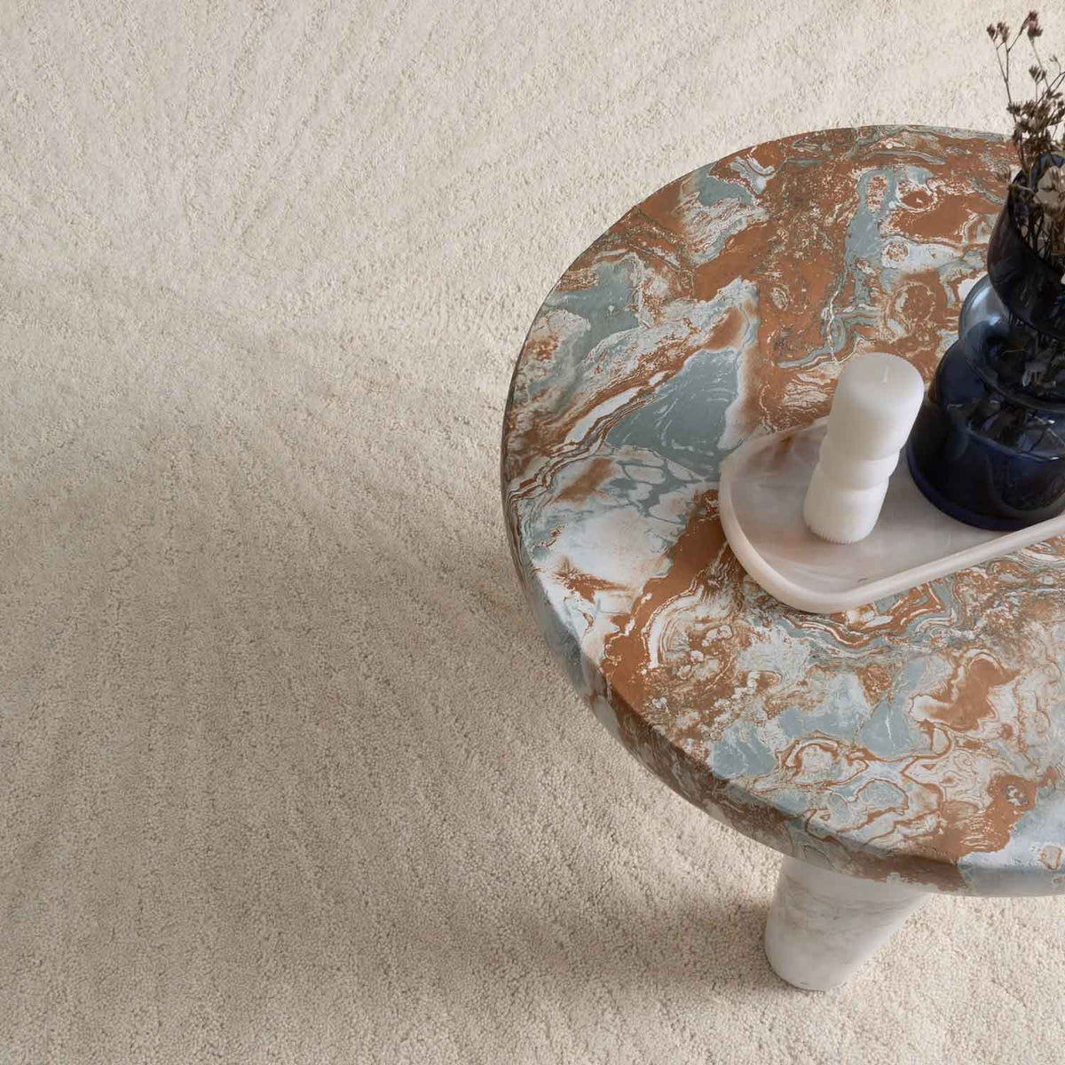 Solace Ivory wool rug with subtle radiating pattern in soft neutral tones