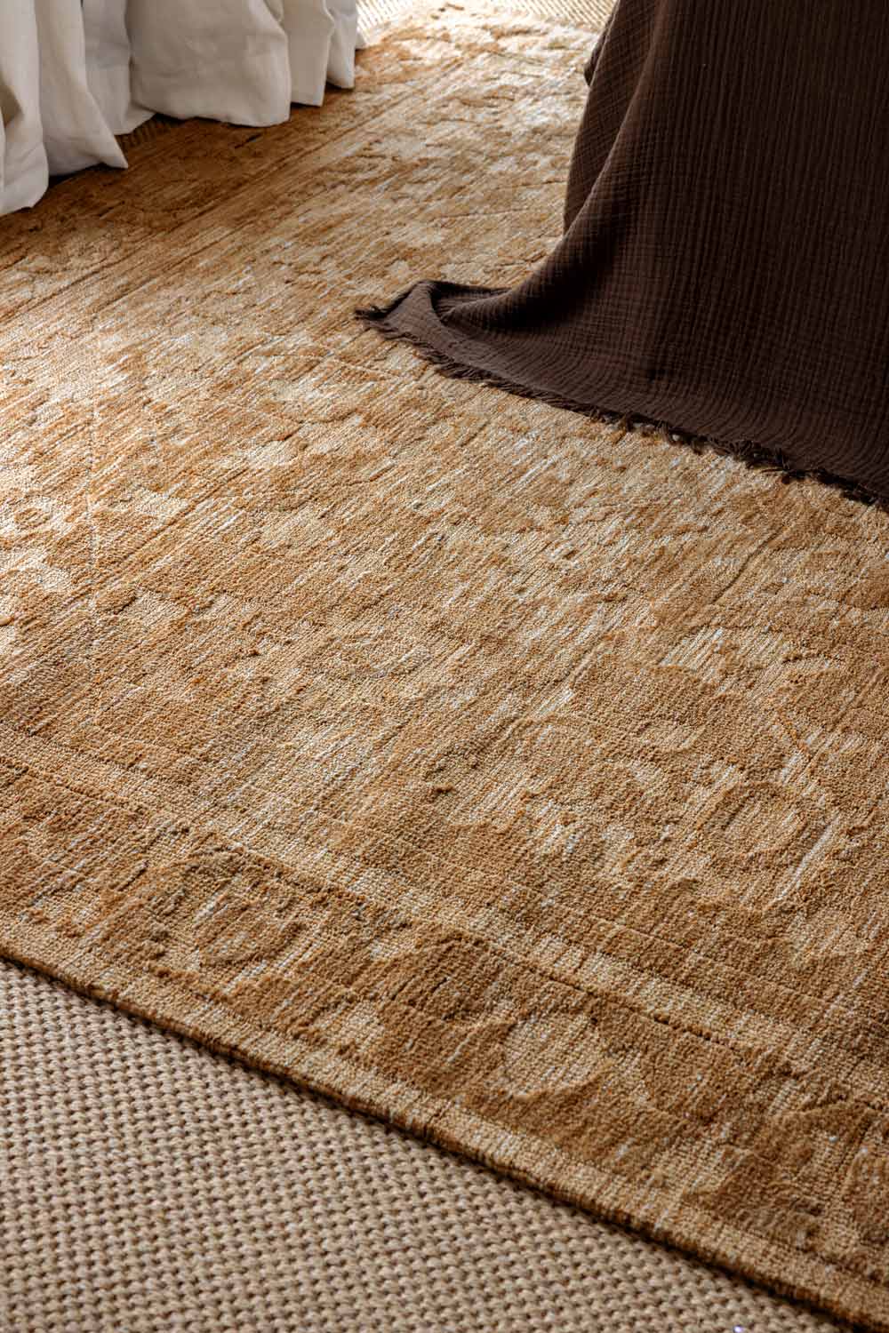 Vivienne Manor traditional distressed rug featuring warm neutral tones and a classic floral pattern.