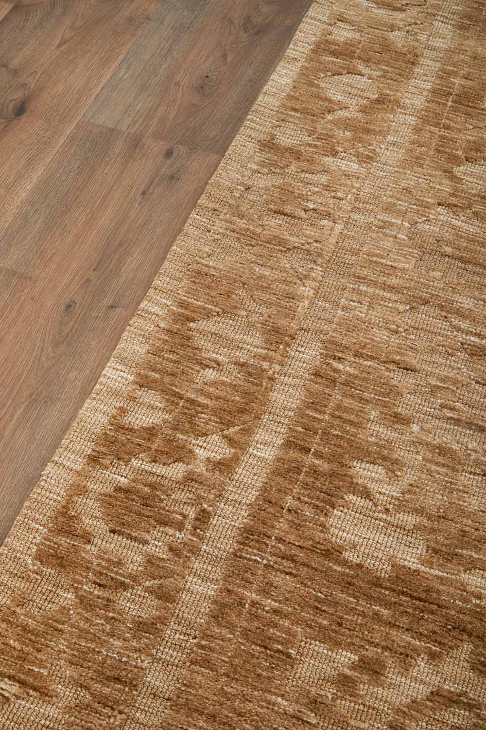 Vivienne Manor traditional distressed rug featuring warm neutral tones and a classic floral pattern.